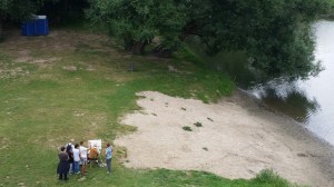 an artist painting and onlookers watching